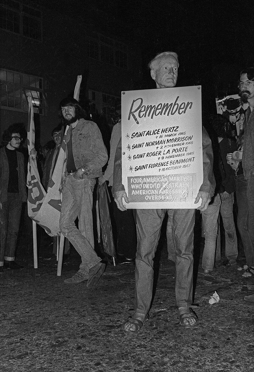 American Martyrs, Man with sign among students oblivious to his message, in those pre-Google days. 30 April mobilization, 1971